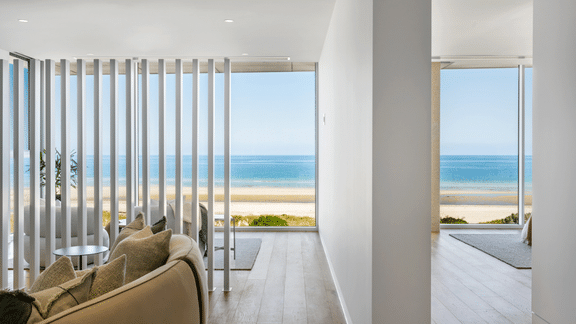 Light-filled modern coastal home with floor-to-ceiling windows and uninterrupted ocean views.
