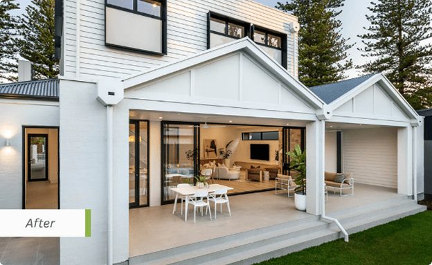 Completed two-storey bungalow extension with open-plan living, large glass doors and a covered alfresco area.